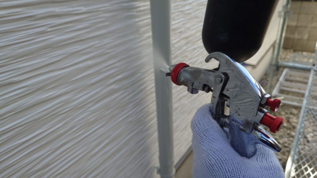 壁に仕上げ材の光触媒プロテクトコーティング（クリスタルシーズンtg）を塗布します。